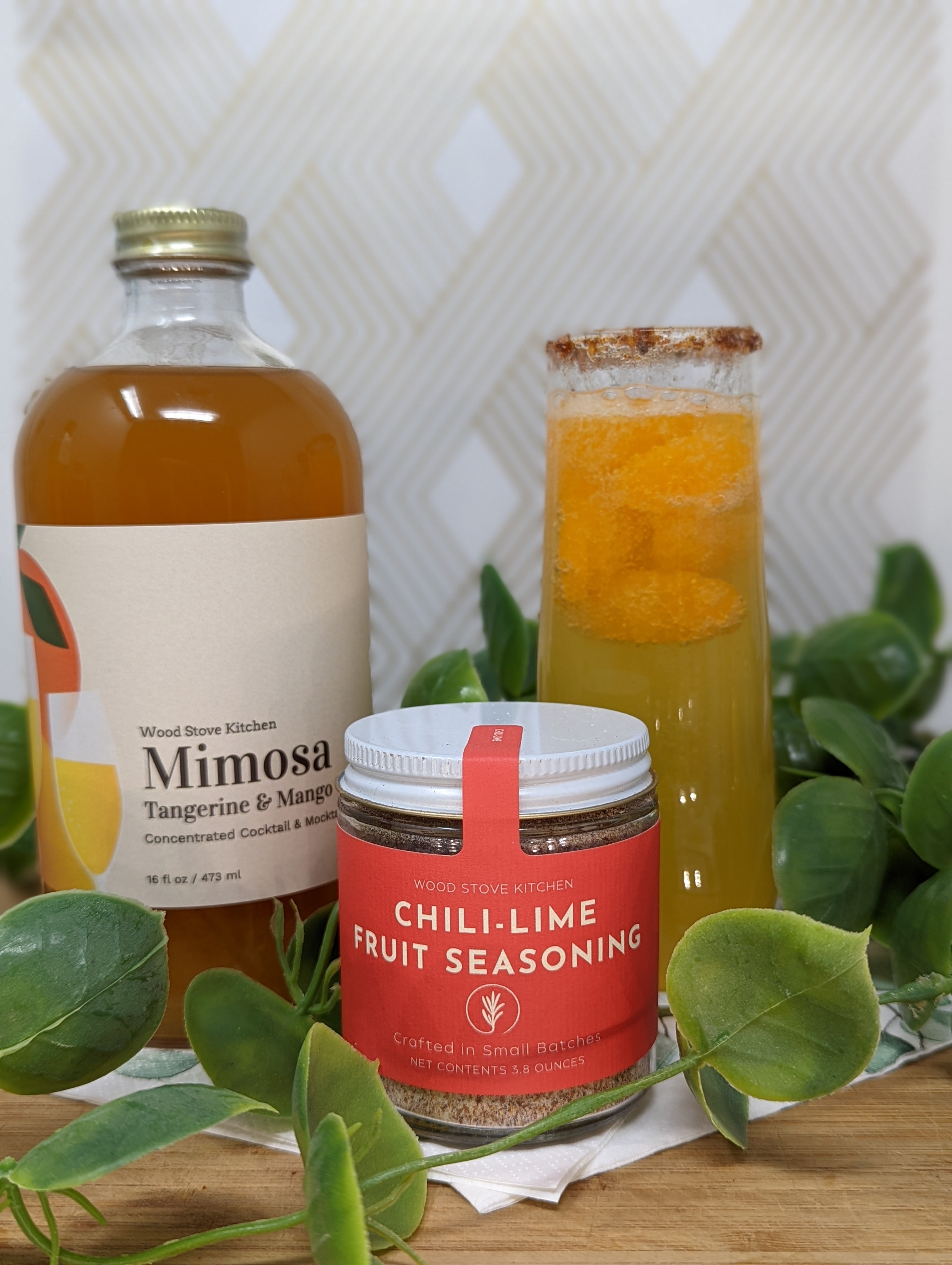 https://woodstovekitchen.com/cdn/shop/articles/Mimosa_16oz_tangerine_mango_Wood_Stove_Kitchen_concentrated_artisanal_all-natural_cocktail_and_mocktail_mixer_-_lifestyle_3.jpg?v=1675106919